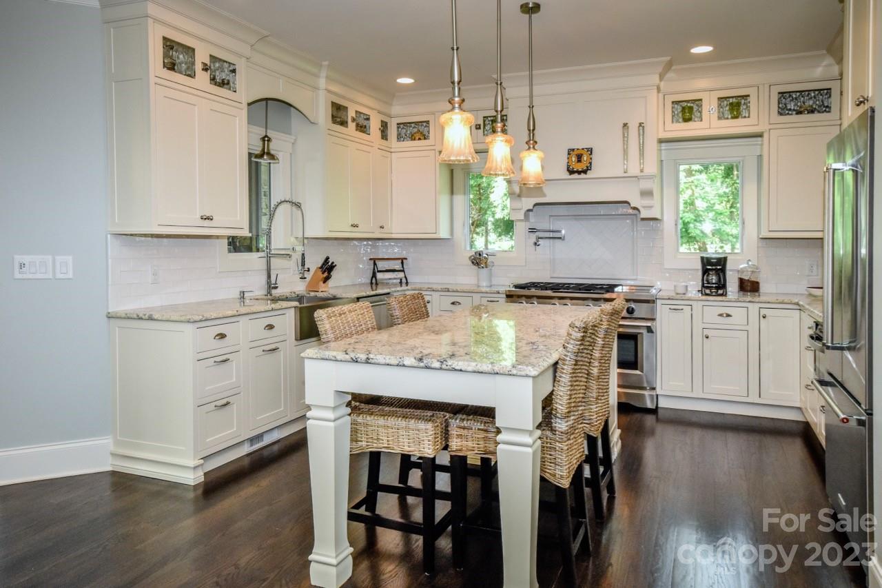 645 Kemp Road Mooresville, NC 28117 - Photo 9 of 48 a kitchen with a sink stove cabinets and wooden floor