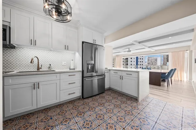 a kitchen with a stove a sink and a refrigerator