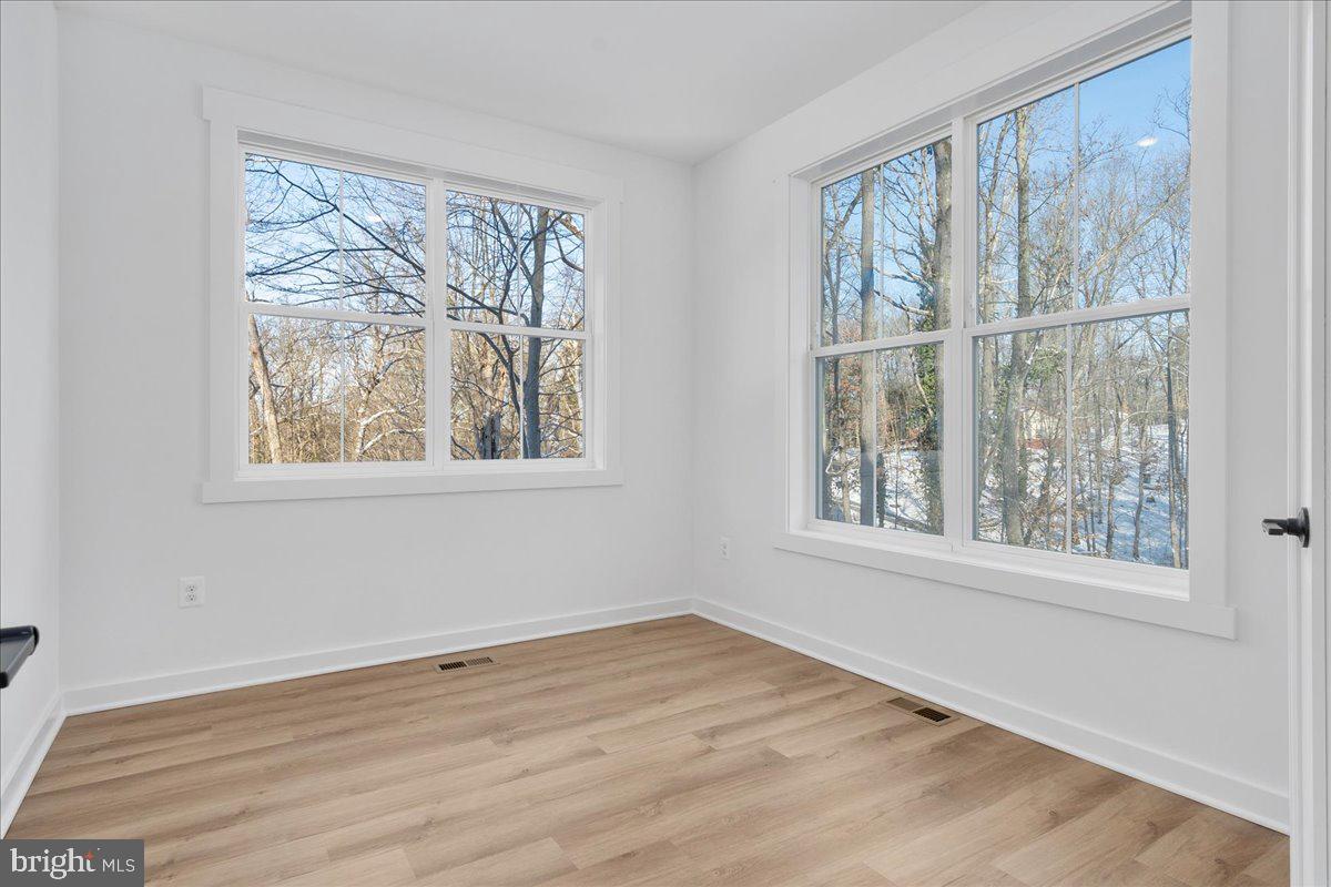 13935 Harrisville Road Mount Airy, MD 21771 - Photo 14 of 73 an empty room with wooden floor and windows