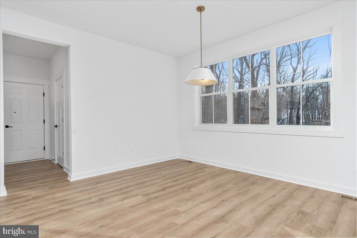 13935 Harrisville Road Mount Airy, MD 21771 - Photo 28 of 73 a view of an empty room with wooden floor and a window