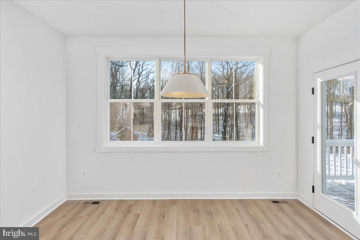 13935 Harrisville Road Mount Airy, MD 21771 - Photo 29 of 73 an empty room with wooden floor and windows