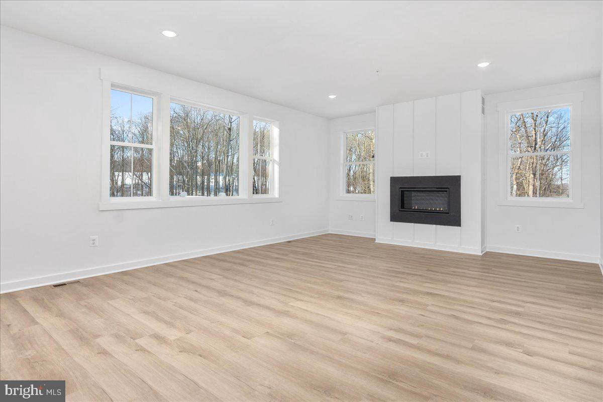 13935 Harrisville Road Mount Airy, MD 21771 - Photo 32 of 73 a view of empty room with wooden floor and fireplace