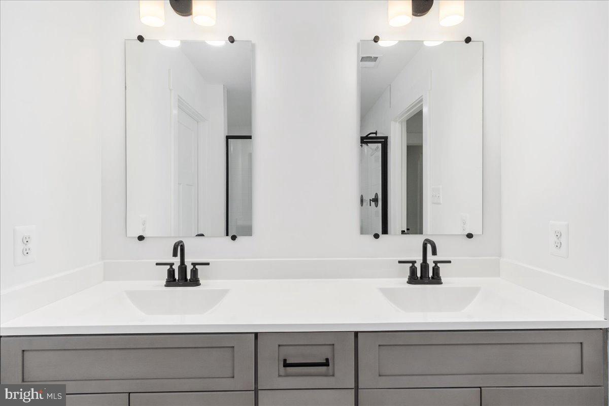 13935 Harrisville Road Mount Airy, MD 21771 - Photo 44 of 73 a bathroom with double vanity sink and mirror
