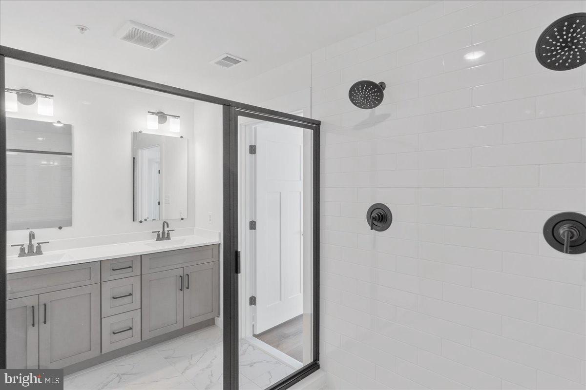 13935 Harrisville Road Mount Airy, MD 21771 - Photo 45 of 73 a spacious bathroom with a double vanity sink a mirror and shower