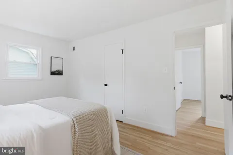 a bedroom with a bed and a hallway
