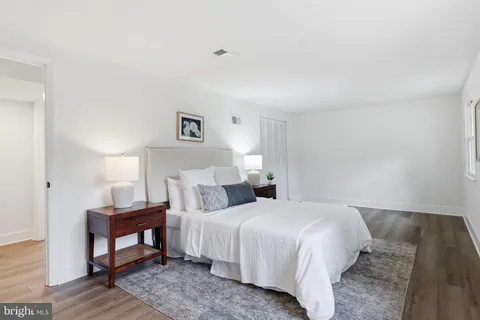 a bedroom with a bed and a night stand