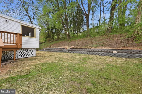 a view of a yard with wooden fence