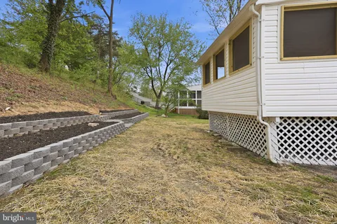 a view of a yard with wooden fence