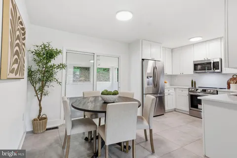 a kitchen with furniture a refrigerator and a sink