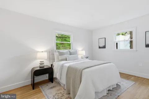a bedroom with a bed and a chair