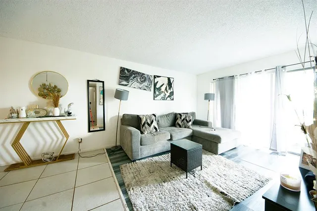 a living room with furniture and a rug