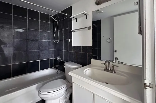 a bathroom with a toilet a sink and shower