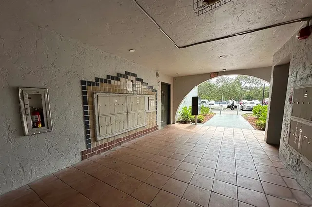 a view of a kitchen with refrigerator and natural light