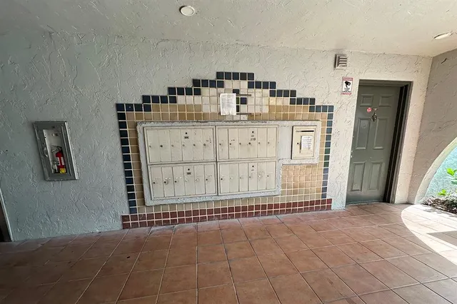 a view of a house with porch and flowers