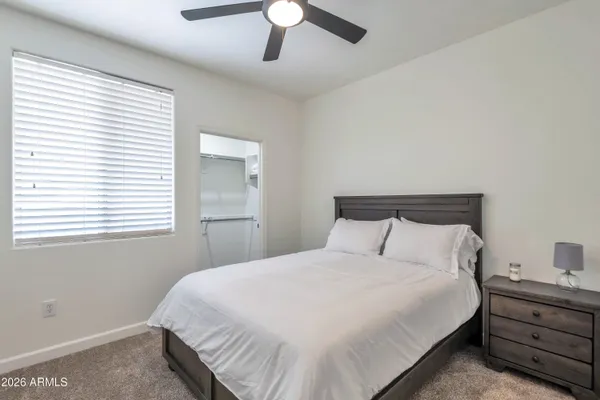 a bedroom with a bed and a ceiling fan