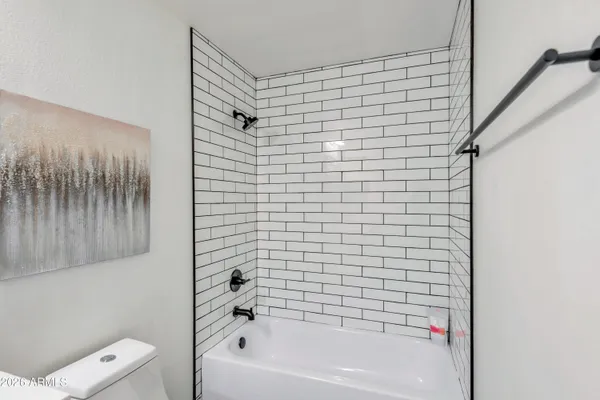 a bathroom with a bathtub and shower