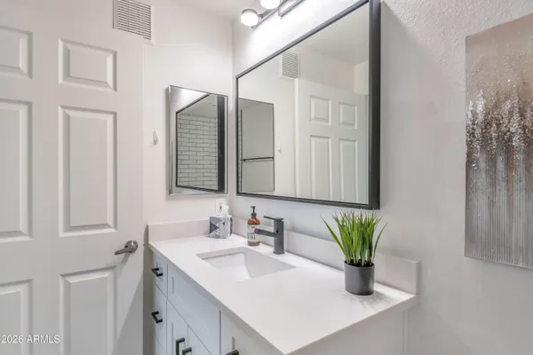 a bathroom with a sink a vanity and a mirror