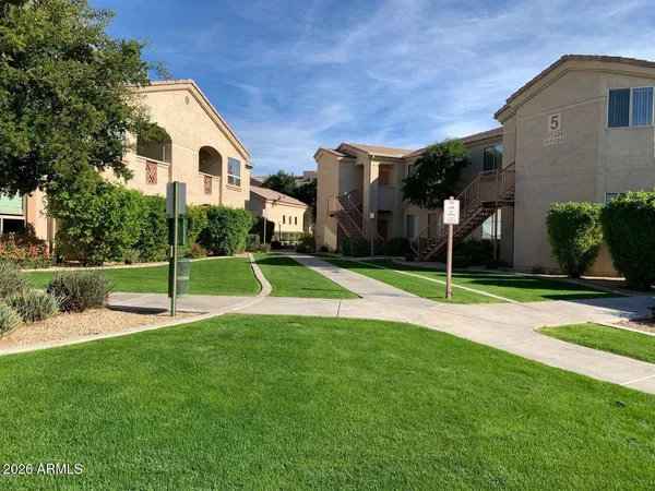 a view of a house with a yard and sitting area