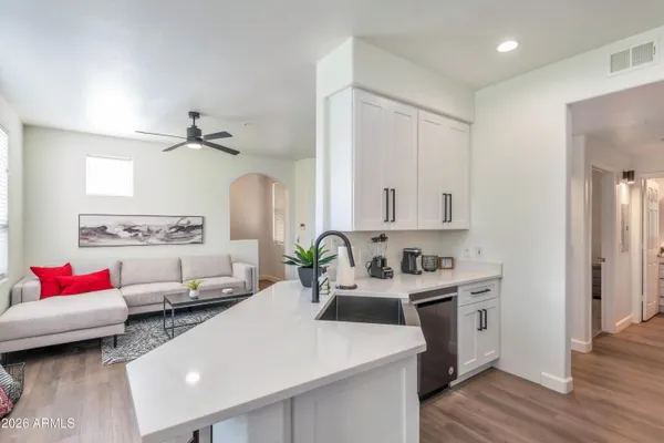 a living room with furniture and a wooden floor