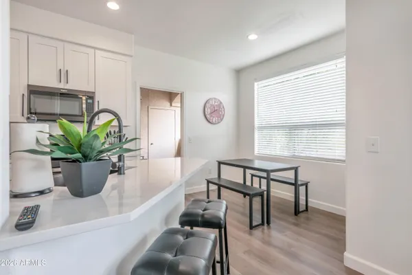 a view of a dining room with furniture and a potted plant