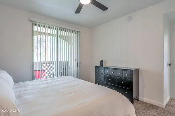 a bedroom with a bed and a ceiling fan