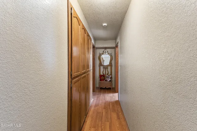 a view of hallway with wooden floor