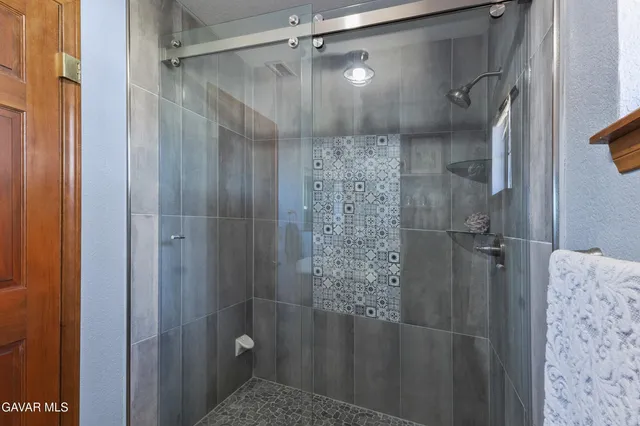 a bathroom with a glass door shower