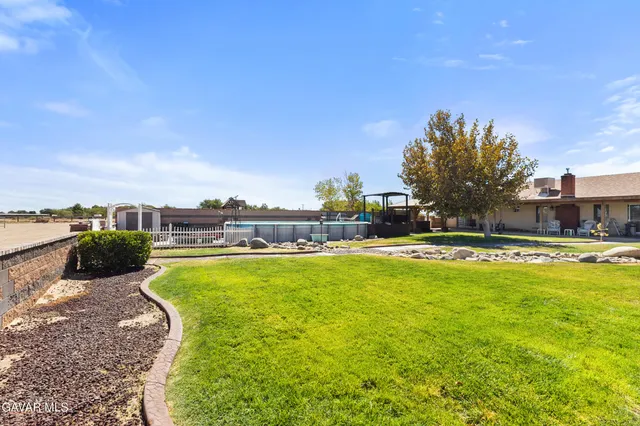 a swimming pool with outdoor seating and yard