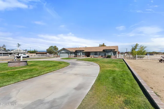 a view of a street with a houses in the back