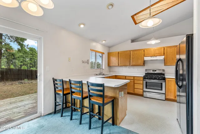 a kitchen with stainless steel appliances granite countertop a stove and a refrigerator
