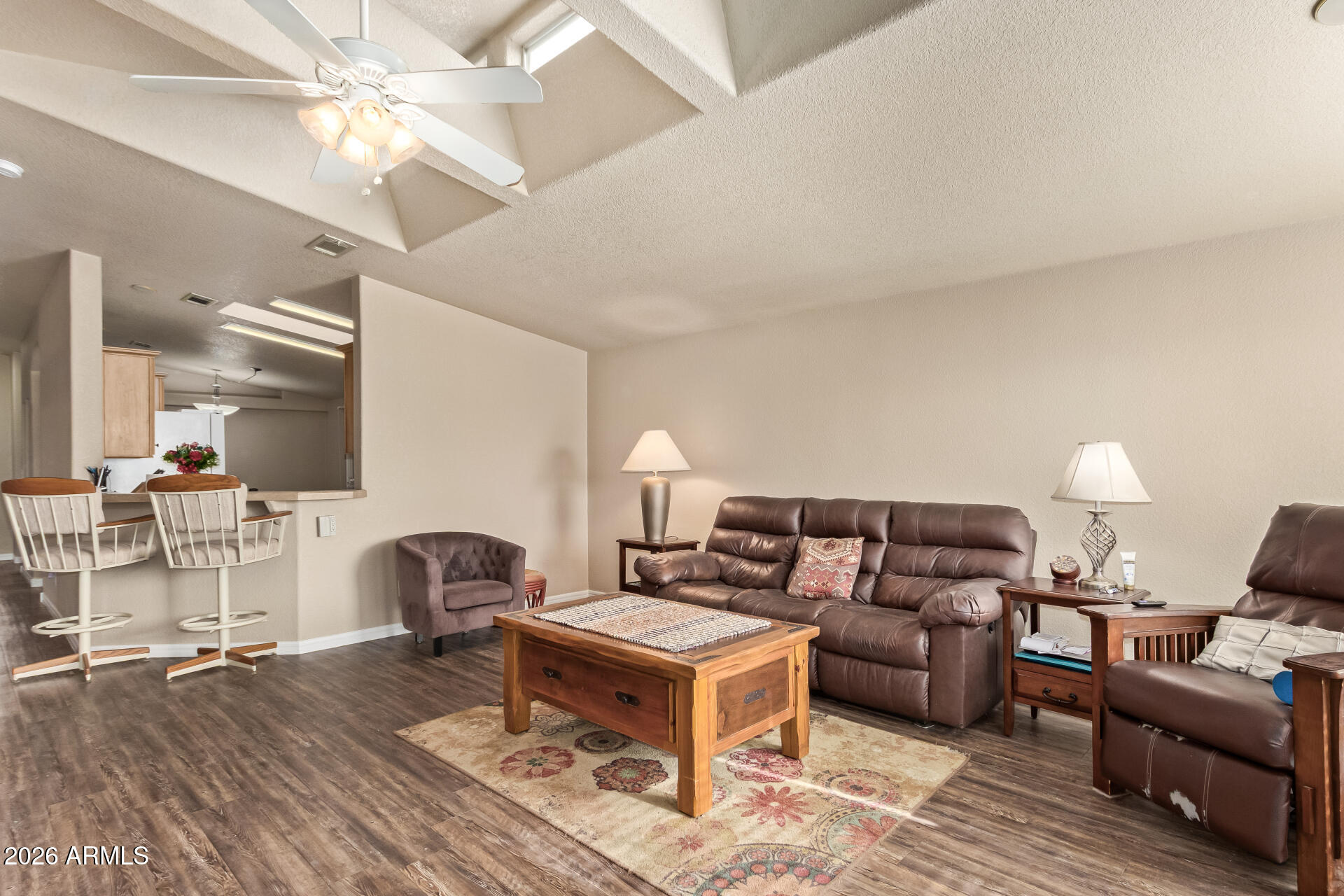3301 South Goldfield Road, Unit 4028 Apache Junction, AZ 85119 - Photo 17 of 40 a living room with furniture a flat screen tv and a fireplace