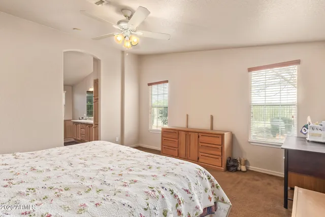 a bedroom with a bed dresser and a window