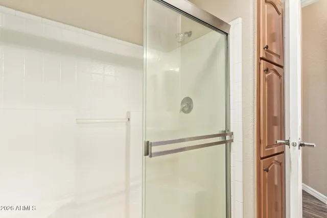 a bathroom with a glass shower door