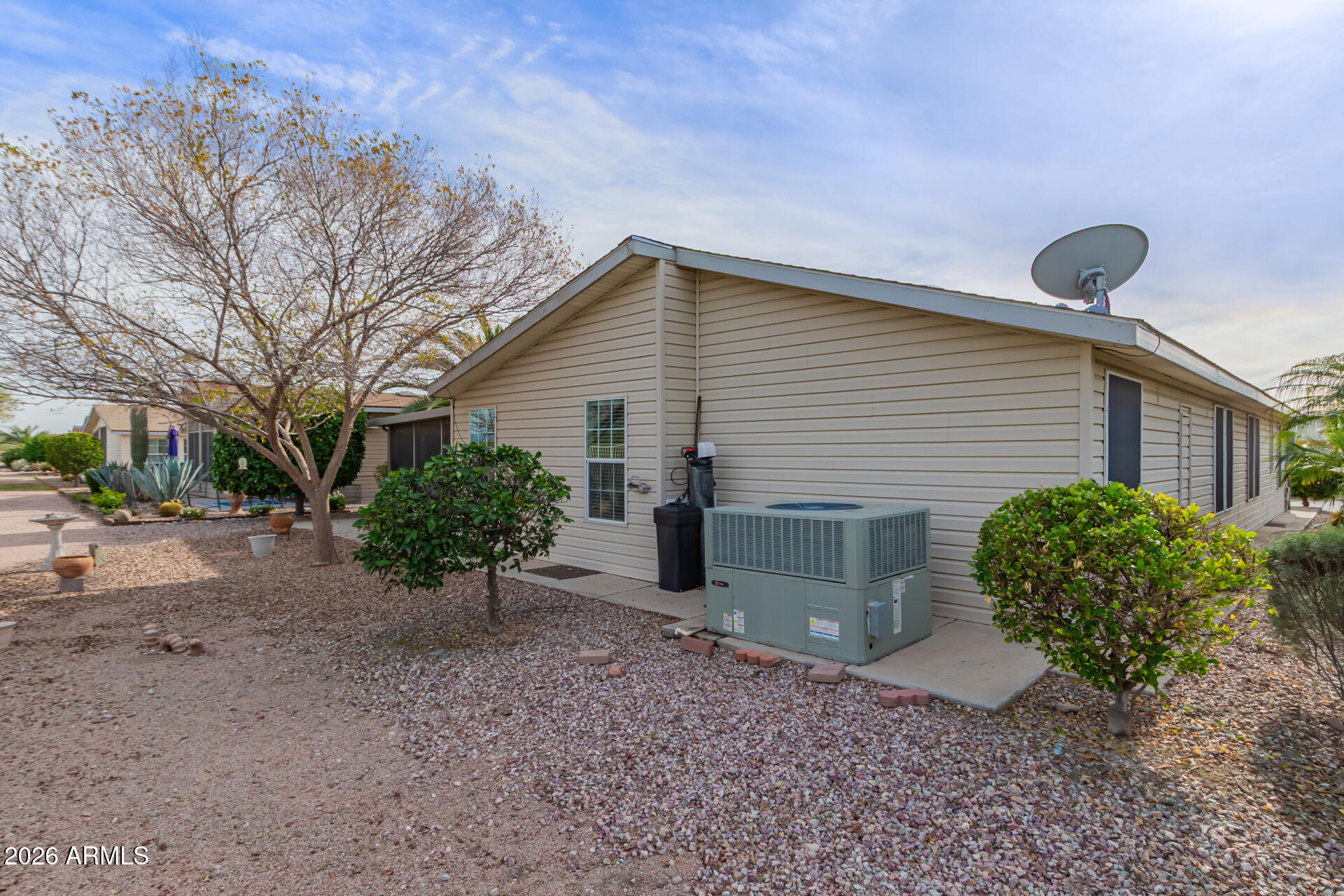 3301 South Goldfield Road, Unit 4028 Apache Junction, AZ 85119 - Photo 32 of 40 a view of a house with a yard and a large tree