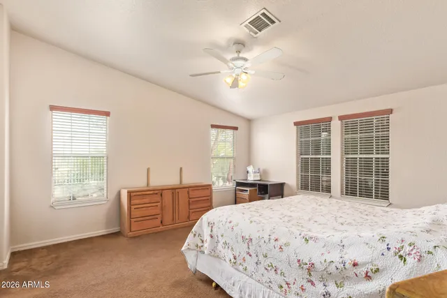 a bedroom with a large bed and a window