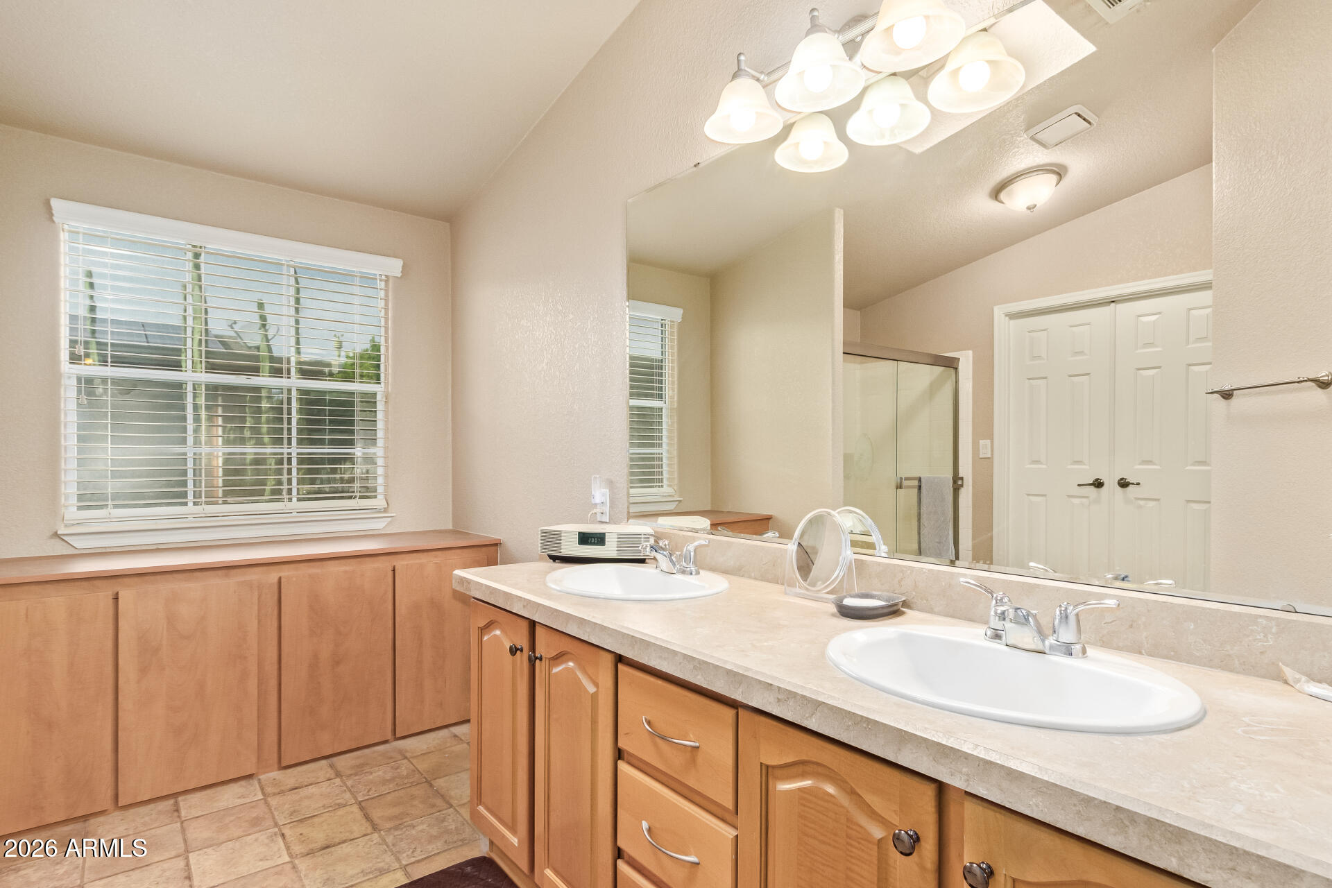 3301 South Goldfield Road, Unit 4028 Apache Junction, AZ 85119 - Photo 9 of 40 a bathroom with a double vanity sink and a mirror
