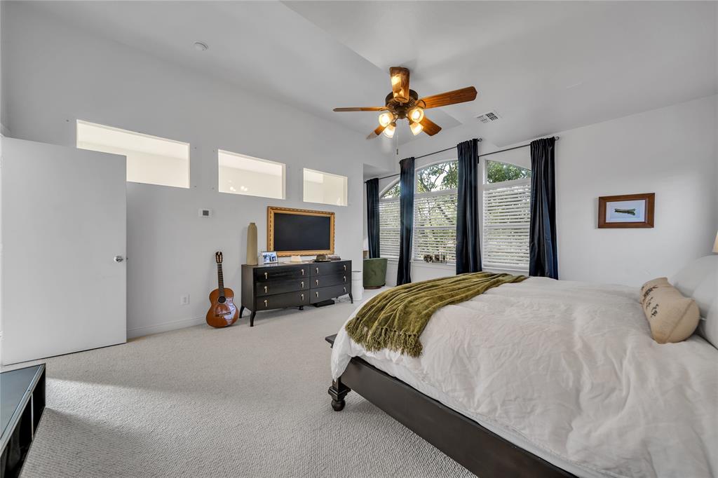 4317 Cedar Springs Road, Unit A Dallas, TX 75219 - Photo 12 of 27 a bed room with a bed a flat tv screen and a large window