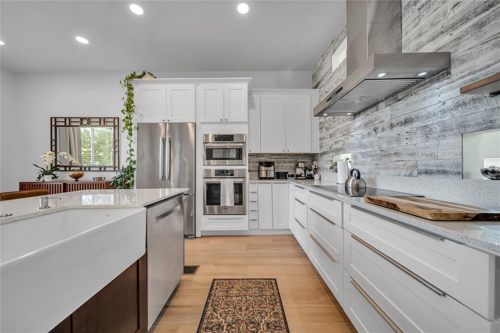 4317 Cedar Springs Road, Unit A Dallas, TX 75219 - Photo 5 of 27 a large kitchen with a large window and stainless steel appliances