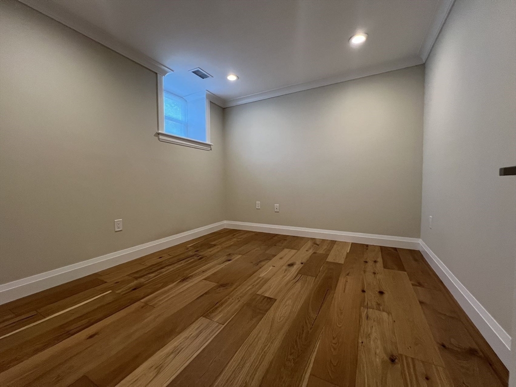 23 Winslow Road, Unit 1 Brookline, MA 02446 - Photo 20 of 27 a view of wooden floor in a room