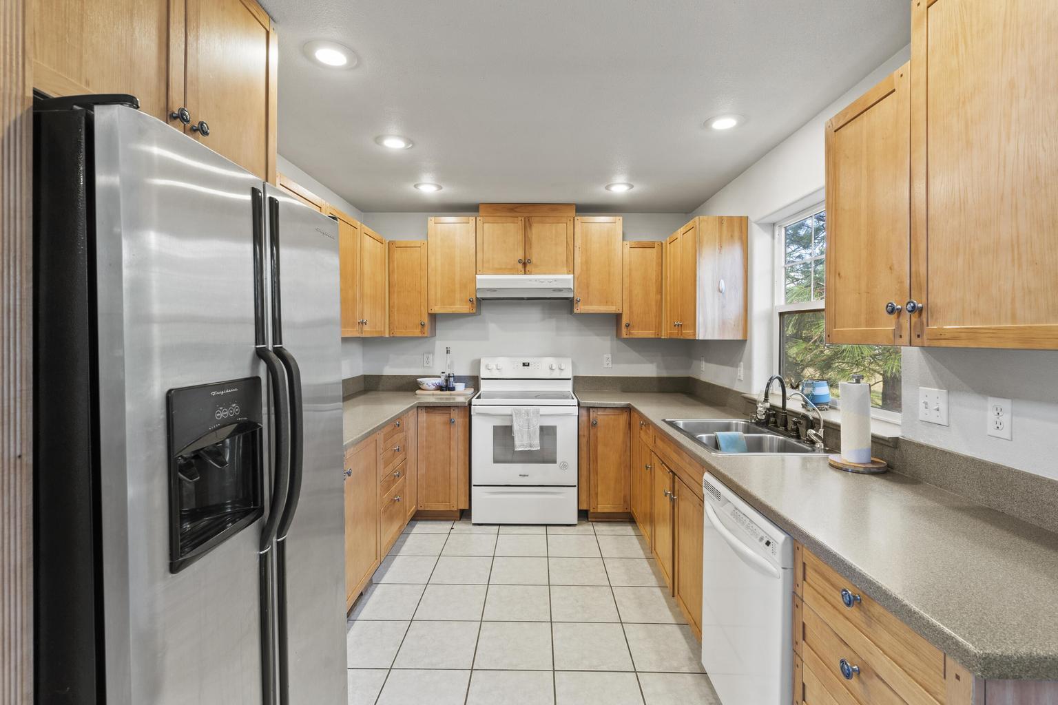 1190 Cedar Flat Road Williams, OR 97544 - Photo 8 of 45 a kitchen with stainless steel appliances granite countertop a refrigerator a sink a stove and oven
