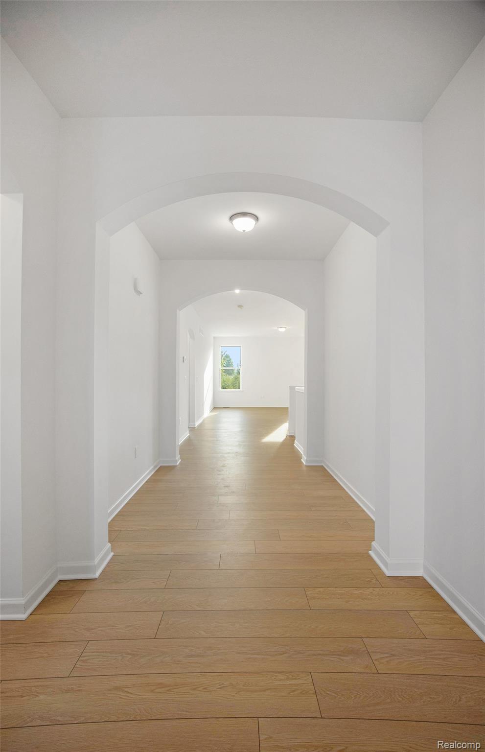 68788 Place Road New Haven, MI 48050 - Photo 15 of 29 Hall featuring light wood finished floors and arched walkways