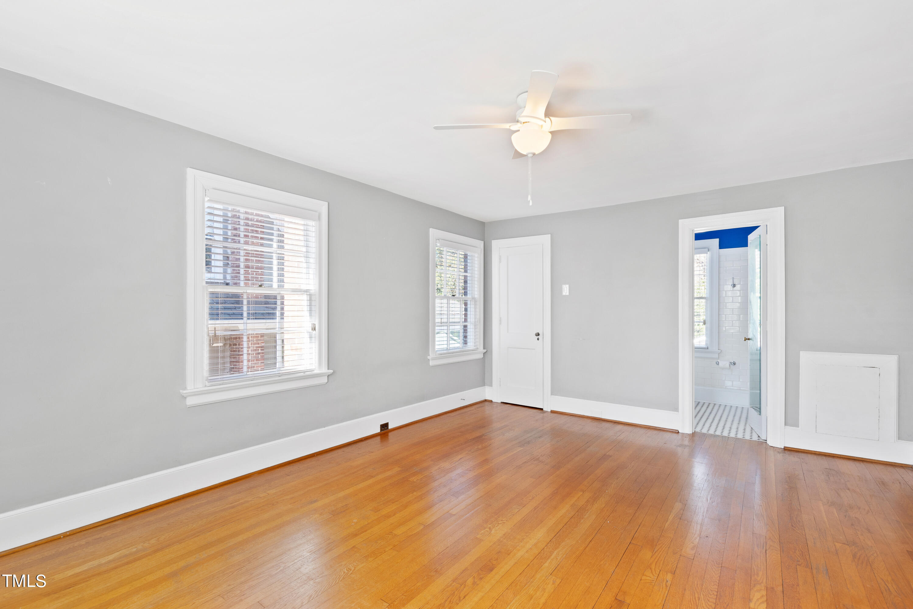 305 Hillcrest Road Raleigh, NC 27605 - Photo 23 of 45 a view of an empty room with wooden floor and a window