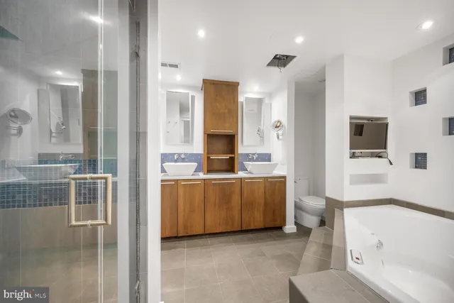 a bathroom with a tub sink and mirror