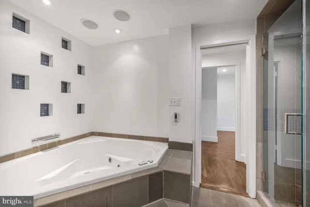 a bathroom with a bathtub and a shower