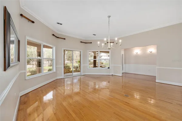 a kitchen with stainless steel appliances kitchen island wooden floors and refrigerator