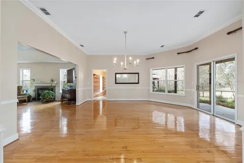 a kitchen with stainless steel appliances granite countertop a refrigerator a stove top oven a sink dishwasher and white cabinets with wooden floor