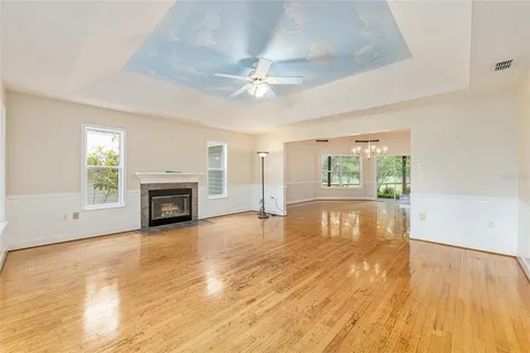 a kitchen with kitchen island granite countertop a sink cabinets and wooden floor
