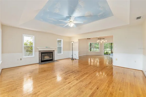 a kitchen with kitchen island granite countertop a sink cabinets and wooden floor