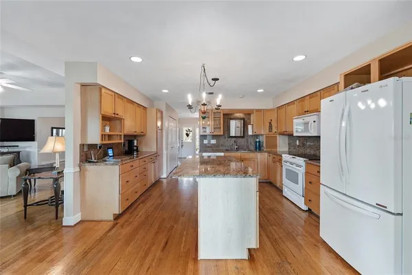 a spacious bathroom with a granite countertop sink mirror and toilet