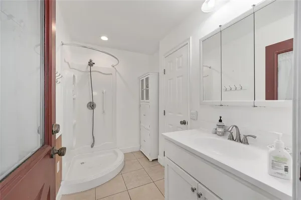 a bathroom with a sink toilet vanity and shower